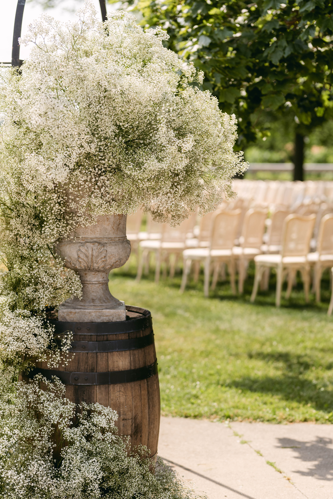 Wine barrel with overflowing baby's breath flowers, ceremony aisle detail at Sorella 1881